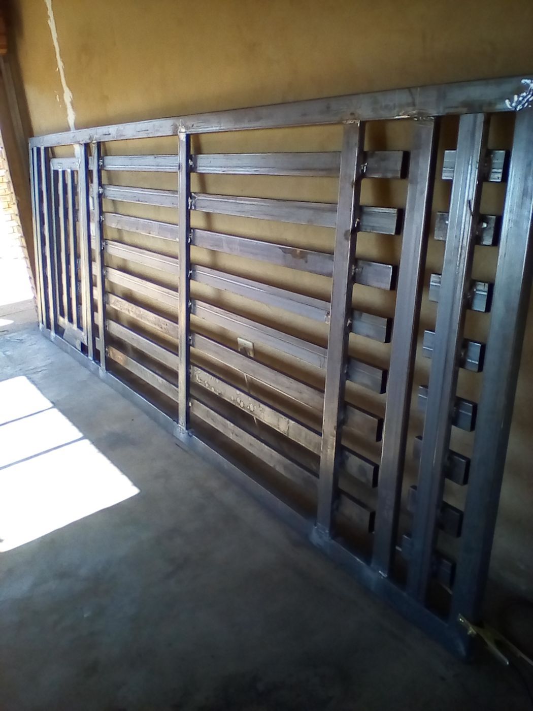 The new gate standing in the workshop after welding and painting